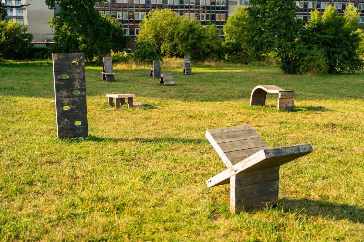 Prague, Czech Republic - August 15, 2025: Urban dog training ground with wooden obstacles, ramps and agility equipment in public park, concept of pet friendly cities and outdoor canine activity spaces. High quality photo